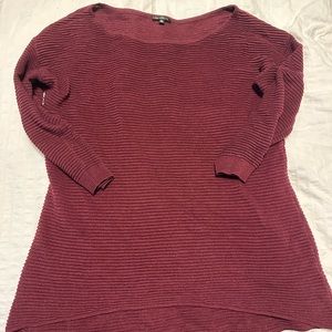 Burgundy red sweater, with 3/4 sleeves.
